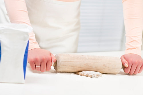 Woman Baking and Rolling Dough