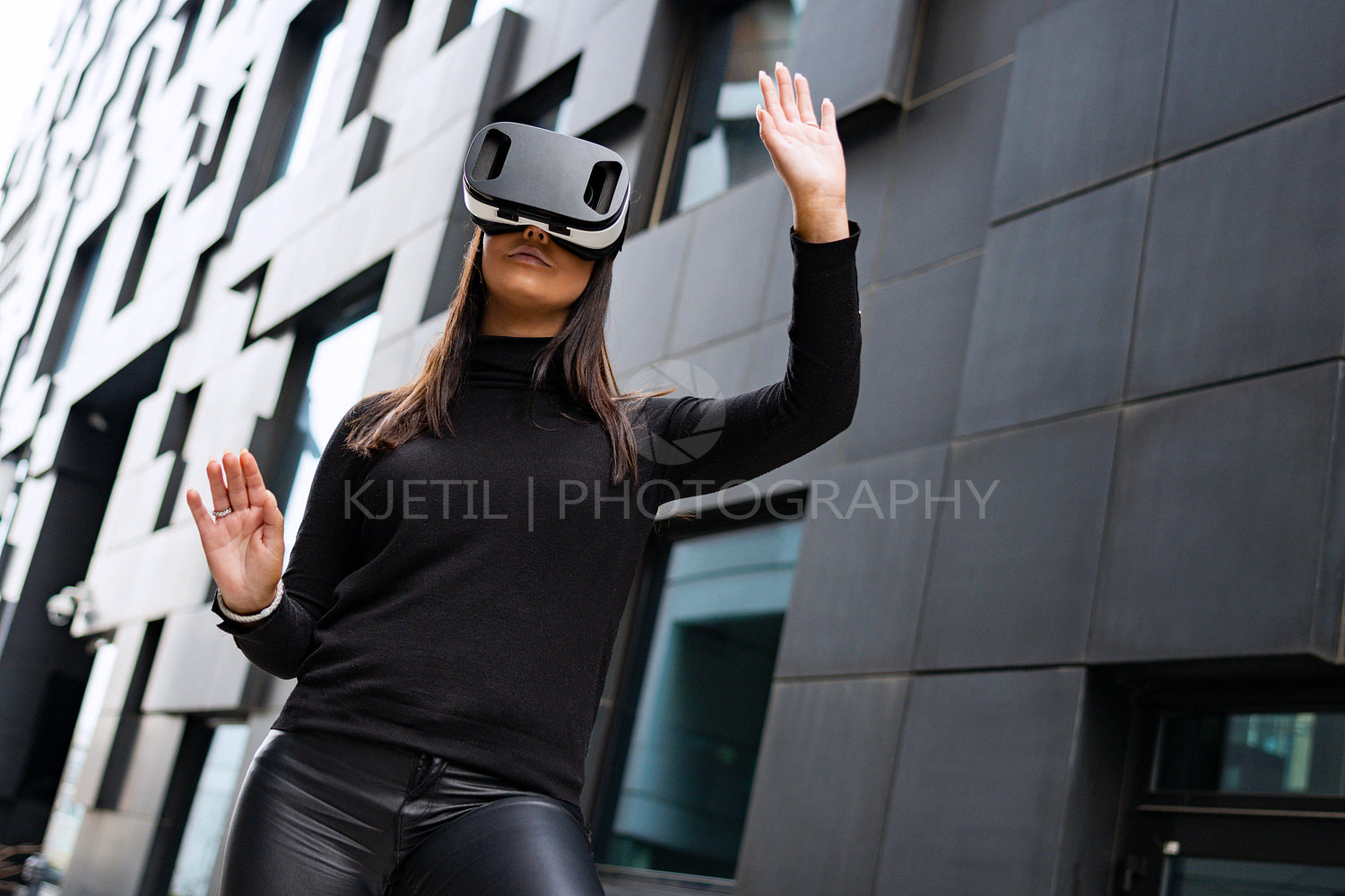 Woman Portrait Using Virtual Reality Glasses And Black Outfit In Futuristic City