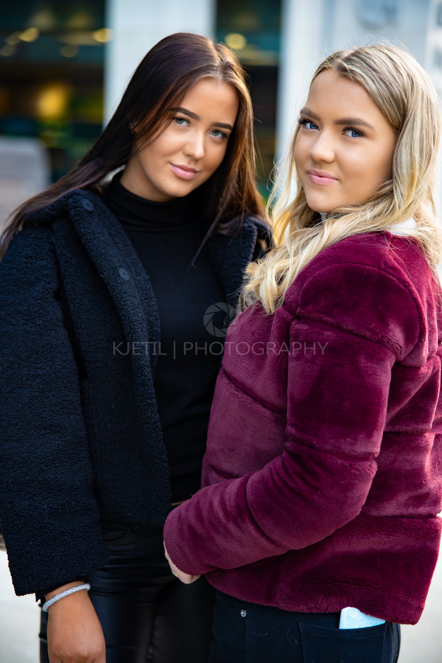 Close Portrait Of Two Smiling Beautiful Young Women Friends In City