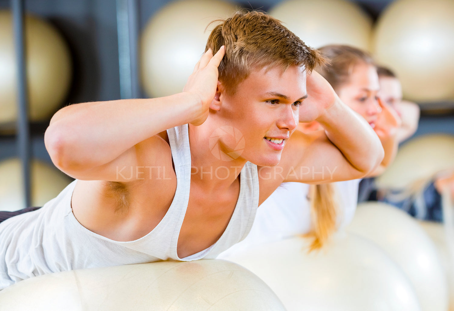 Man Performing Back Extension Exercise With Friends