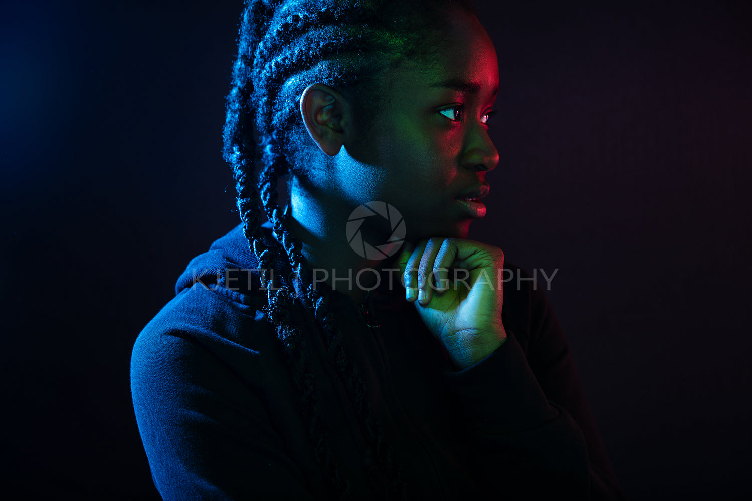 Colorful portrait of thoughtful cool woman with dark skin and braided hair