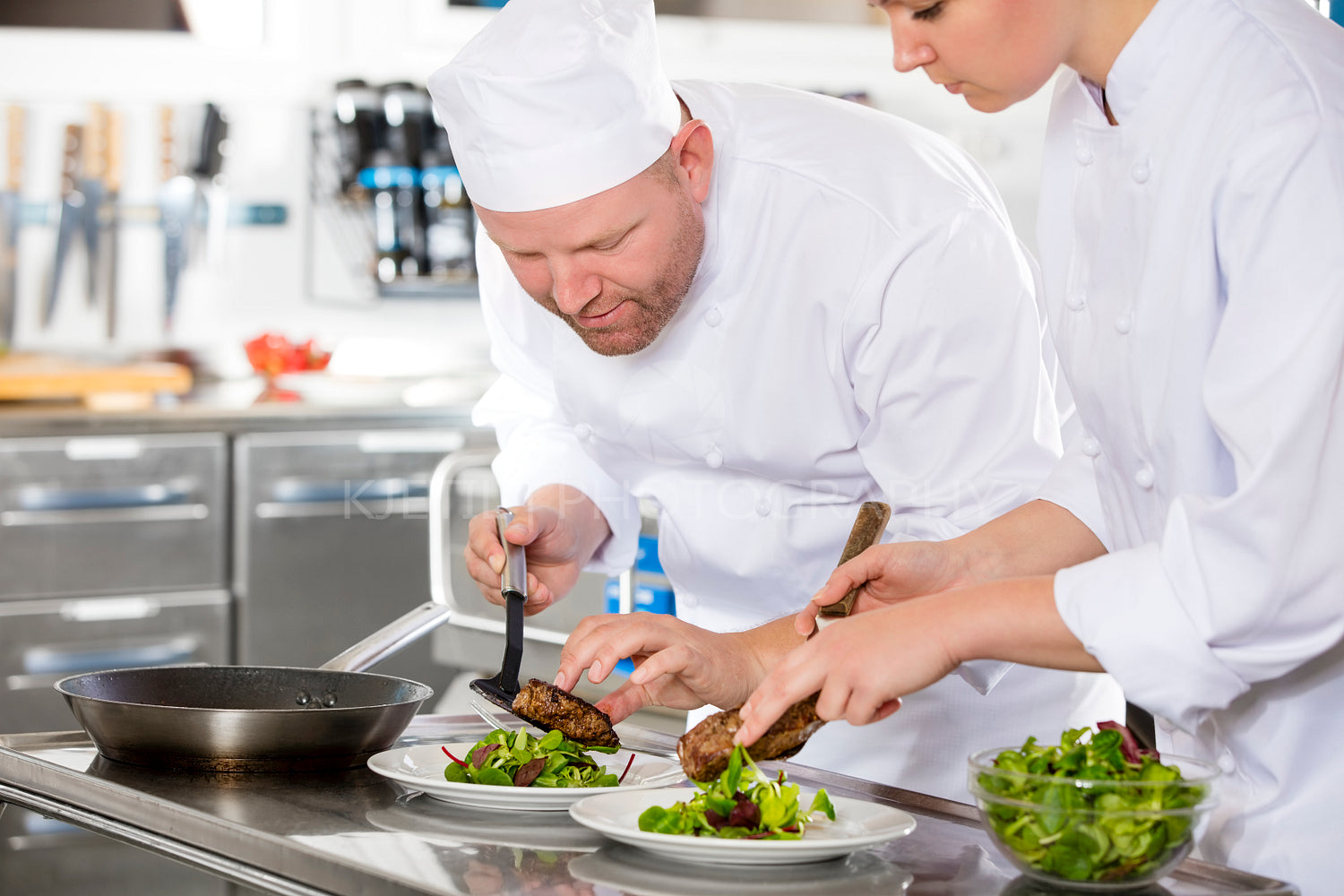 Smiling professional chef prepare steak dish at restaurant