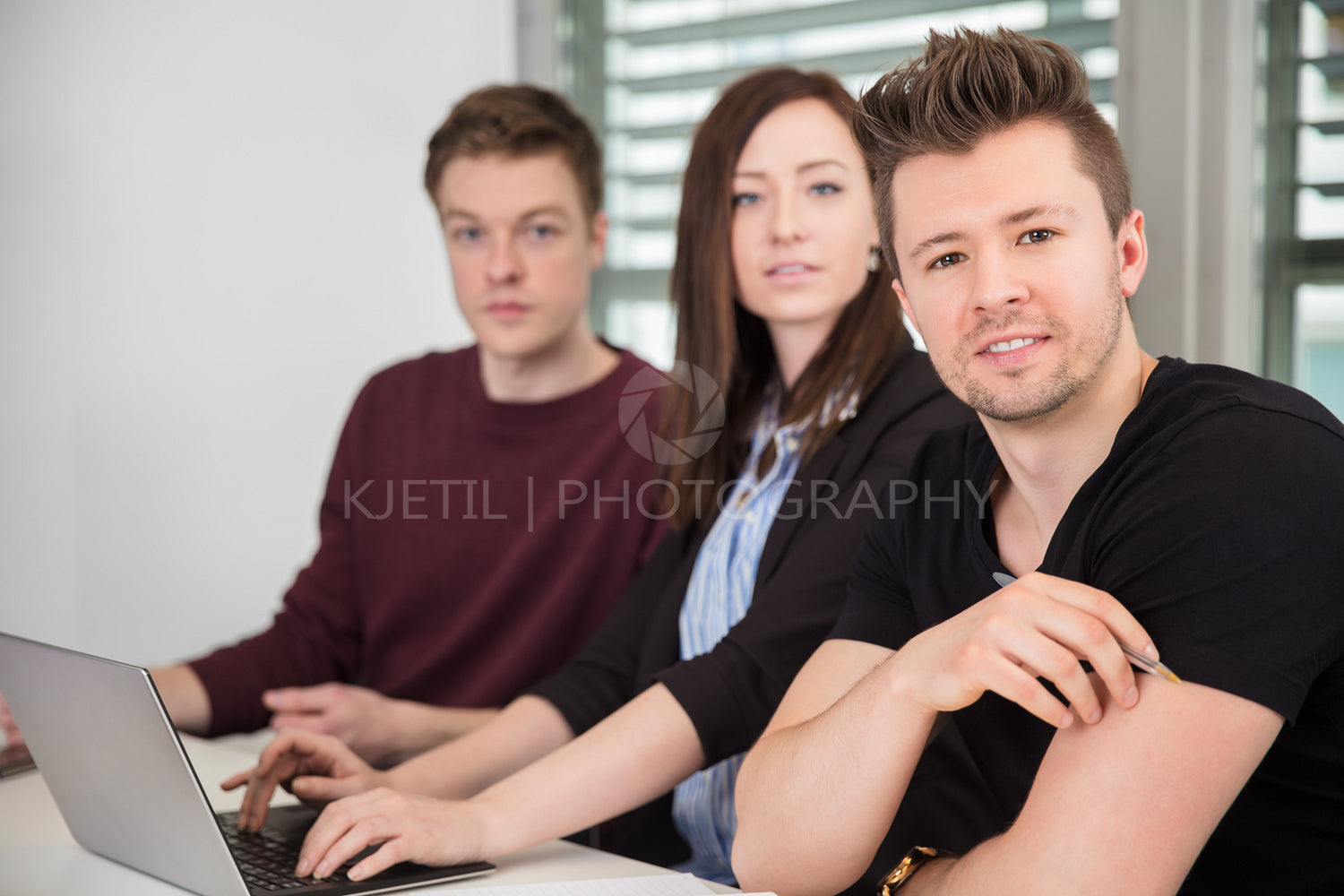 Confident Businessman With Female Colleague In Office