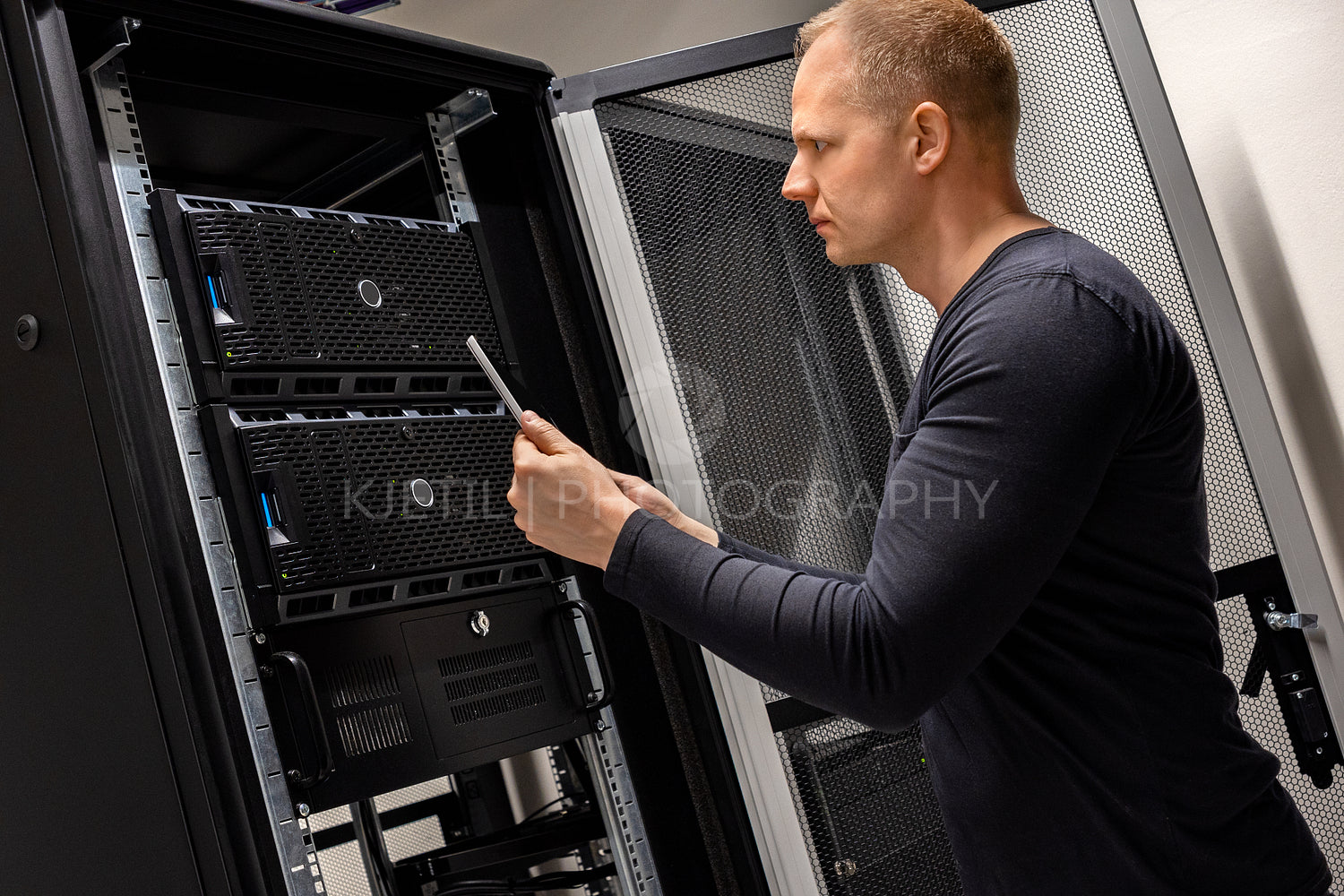 IT Support Holding Digital Tablet Analyzing Servers And Network In Datacenter