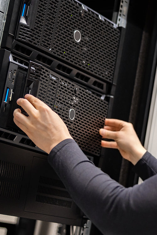 Close-up of IT Consultant Installing Servers In Enterprise Datacenter