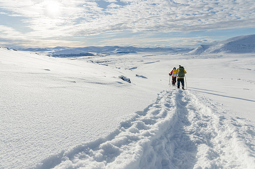 Snow shoe hiking on a beautiful sunny day at the mountain of Dovrefjell