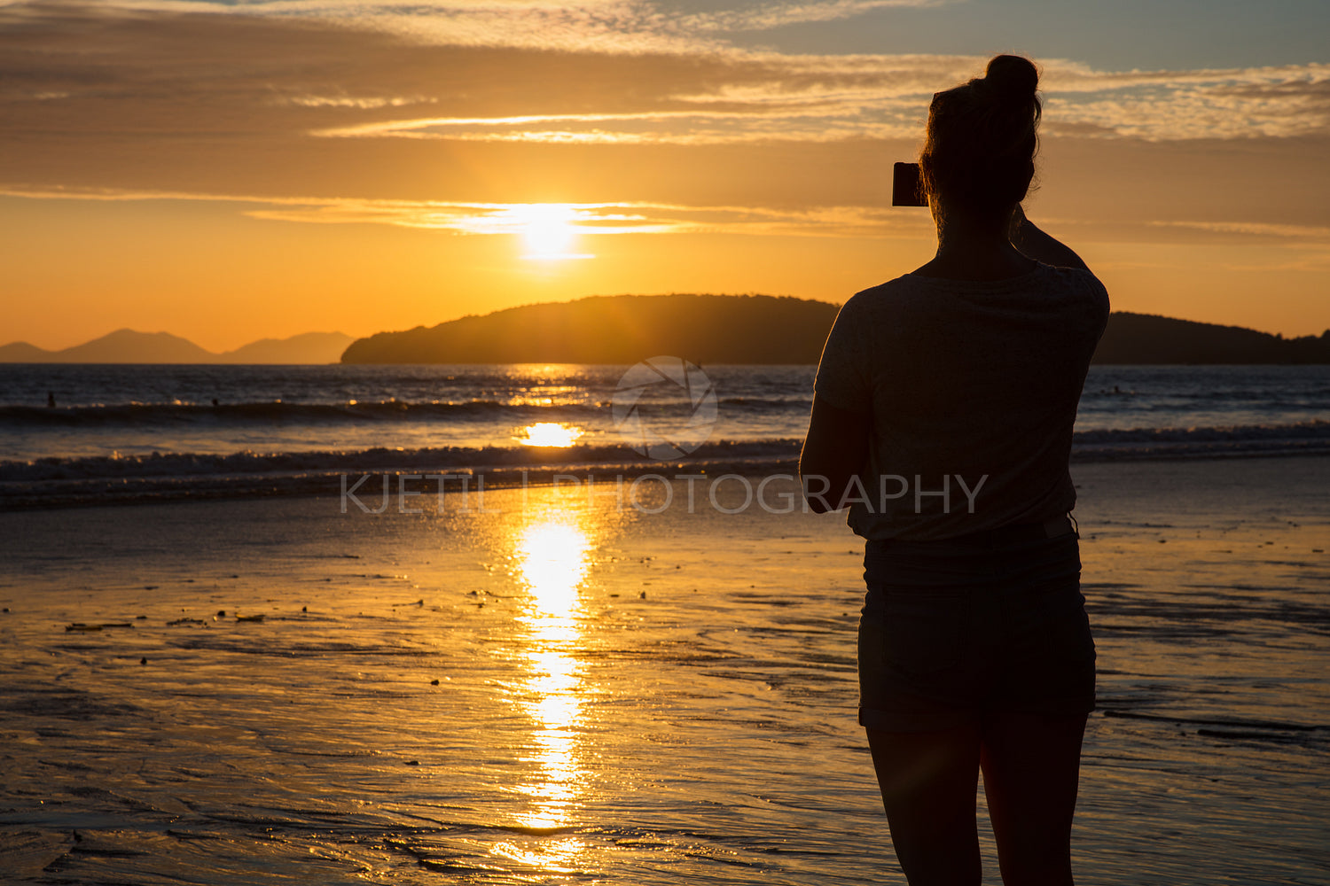 Silhouette Woman Photographing Sunset At Beach