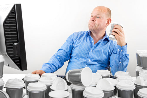 Hardworking business man drinks too much coffee