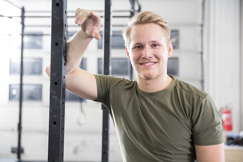 Smiling man rests in fitness gym center