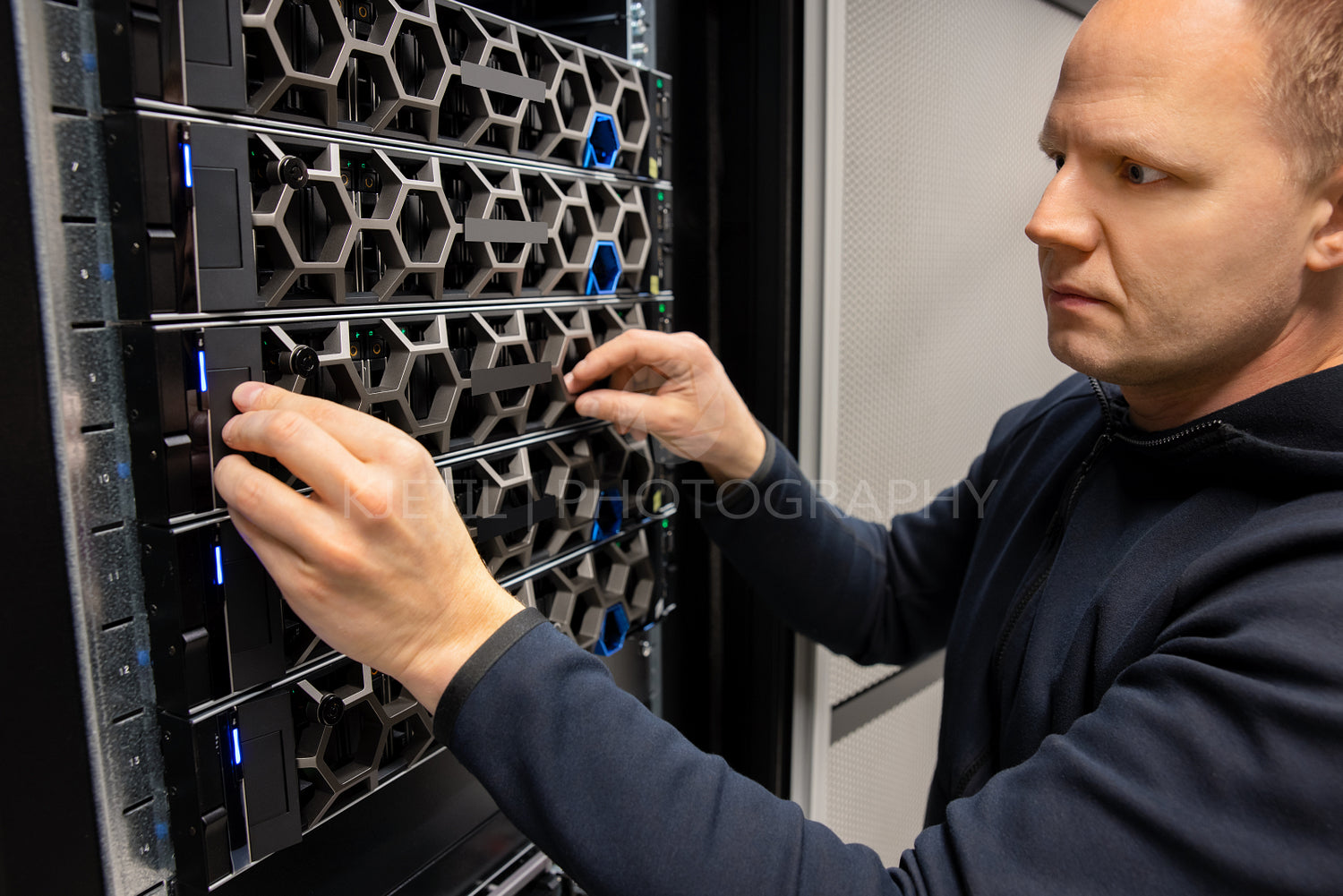 Male Technical Consultant Monitoring Modern Hyperconverged Servers in Datacenter