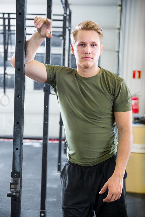 Fit Male Athlete Leaning On Metal Structure At Health Club