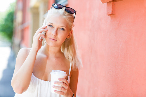 Young blonde girl talking on the phone outdoor