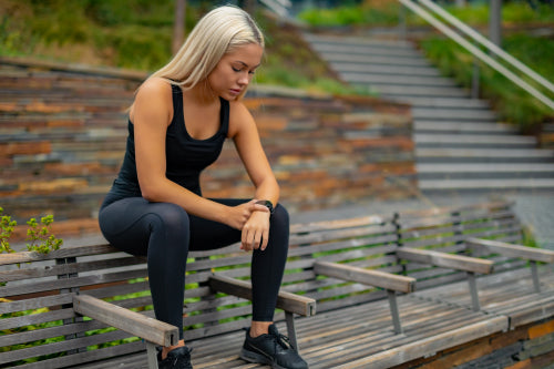 Fitness runner on mobile smart phone app tracking progress for motivation