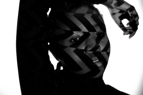 Creative pattern from projection light on beautiful woman with dark skin