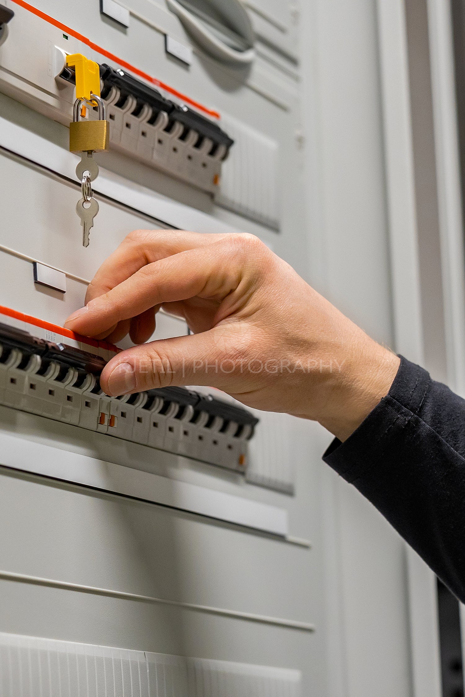 Close-up of Electric Technician Consultant Checking Fuse In Server Room