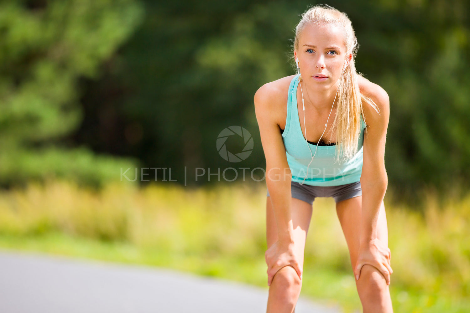 Slim young woman catching her breath after a long run