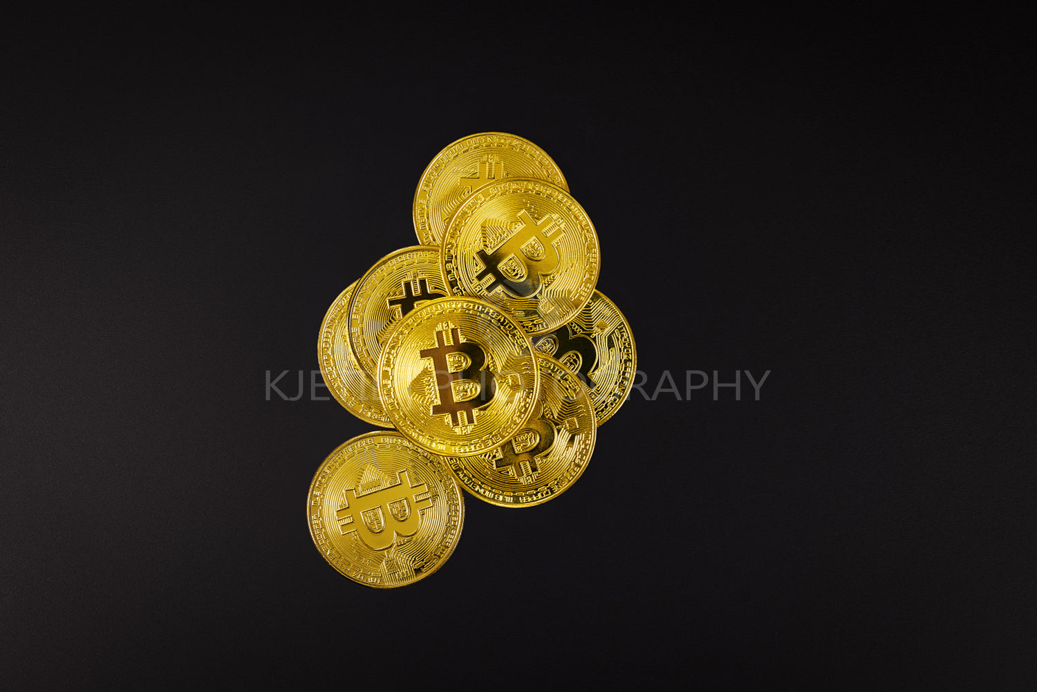 Bitcoin coin on top of various golden cryptocurrencies