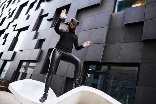 Young Woman Wearing Virtual Reality Glasses In City