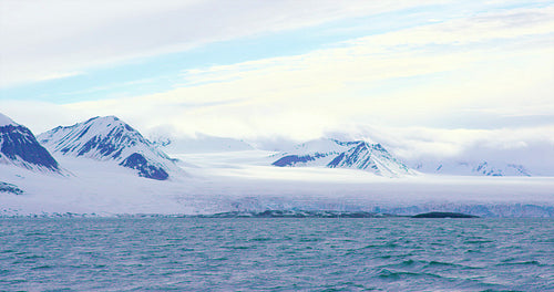 Mountains and a massive glacier in the arctic