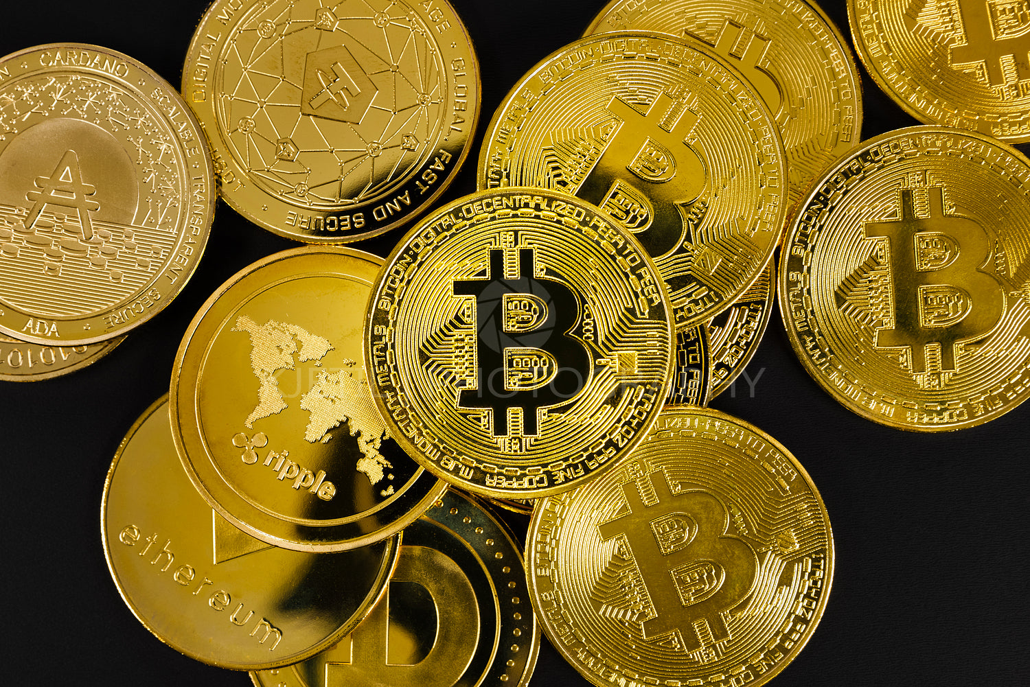 Close-up of Bitcoin coin on top of various golden cryptocurrencies