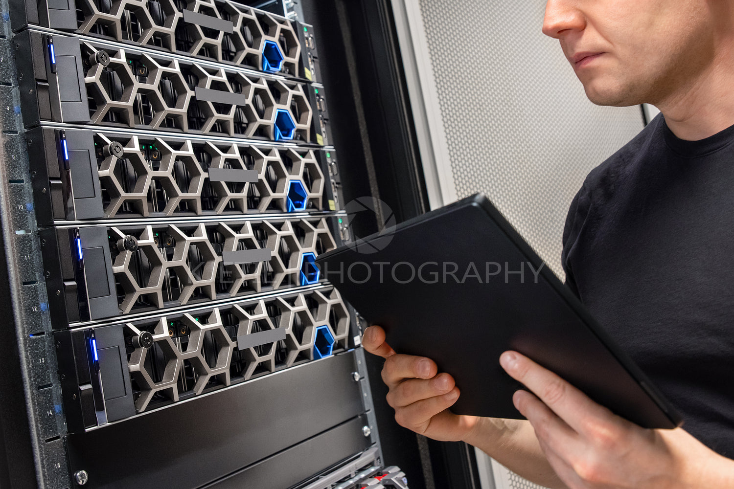 Male IT Support Professional With Digital Tablet Examining Hyper Converged Server Hardware