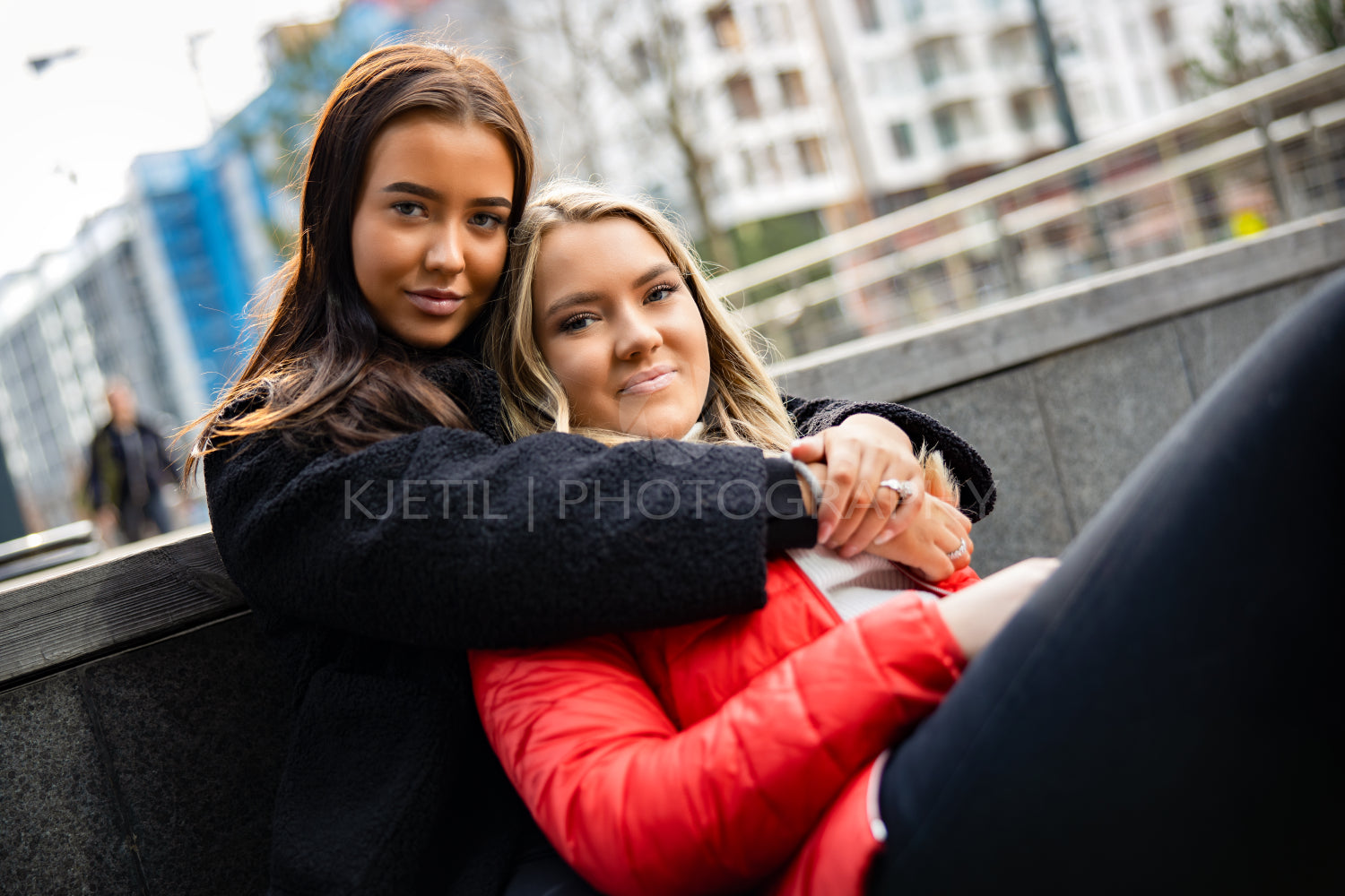 Young Smiling Woman Embracing her Best Friend In City