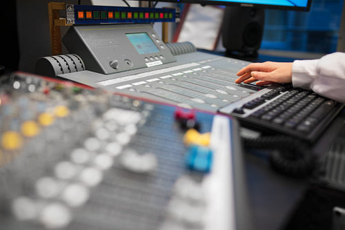 Female Radio Host Using Music Mixer In Studio