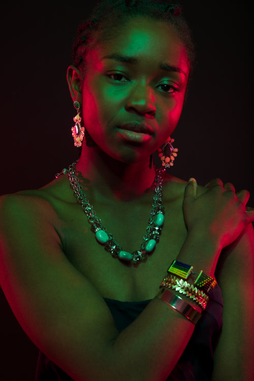 Confident Woman Wearing Jewelry Over Black Background