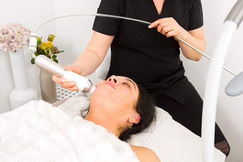 Woman get face treatment at beauty spa