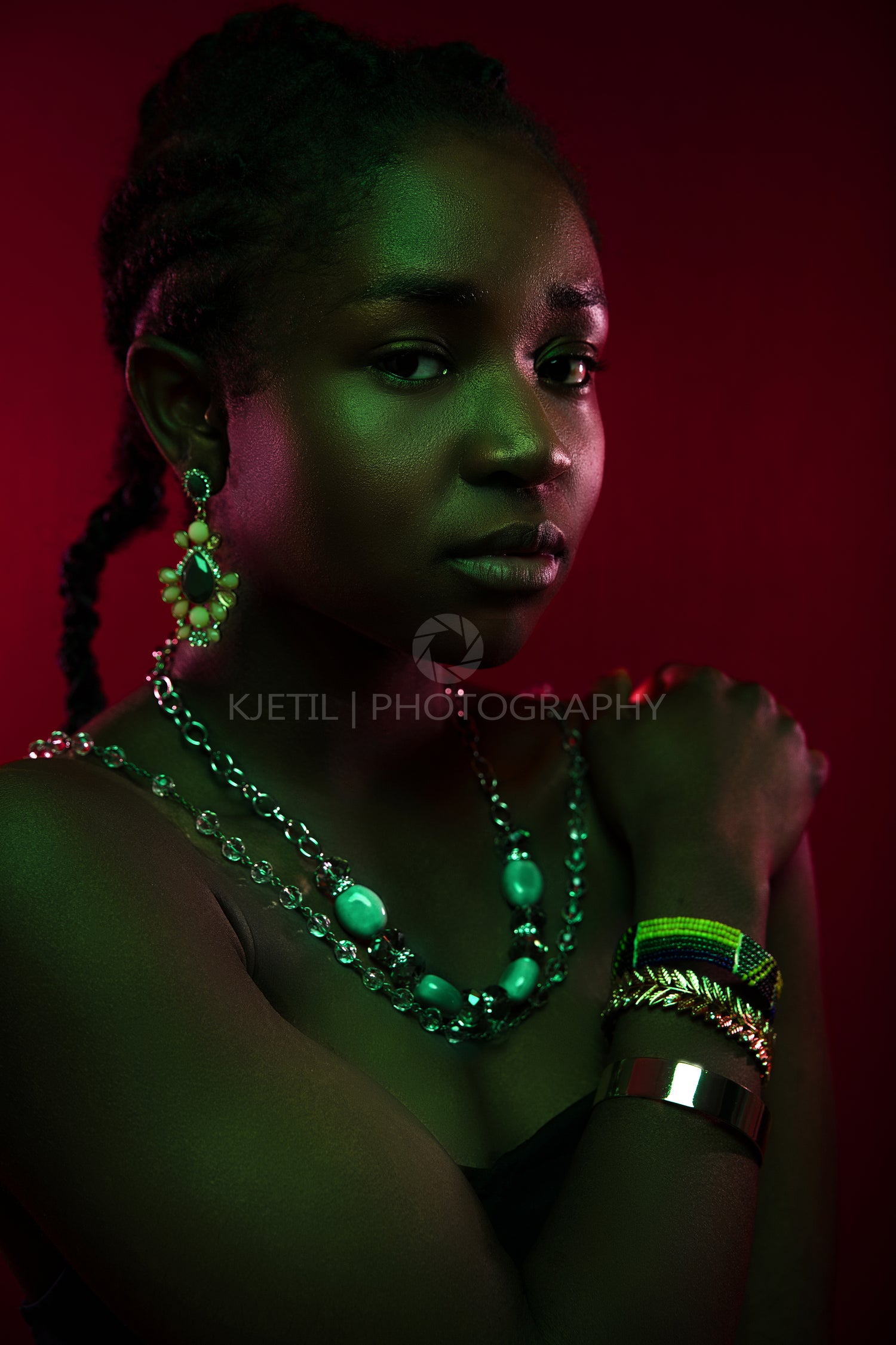 Colorful and creative portrait of beautiful dark african woman on red background
