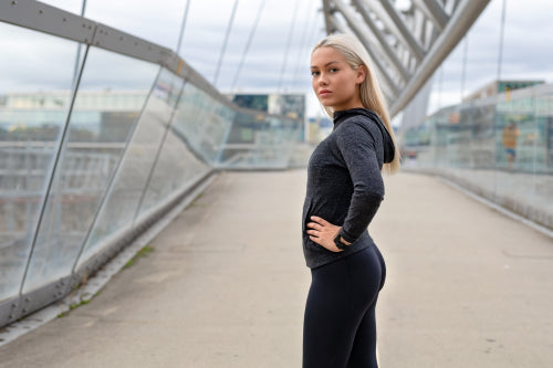 Fit Woman in Black Workout Wear Standing At Modern Bridge In City