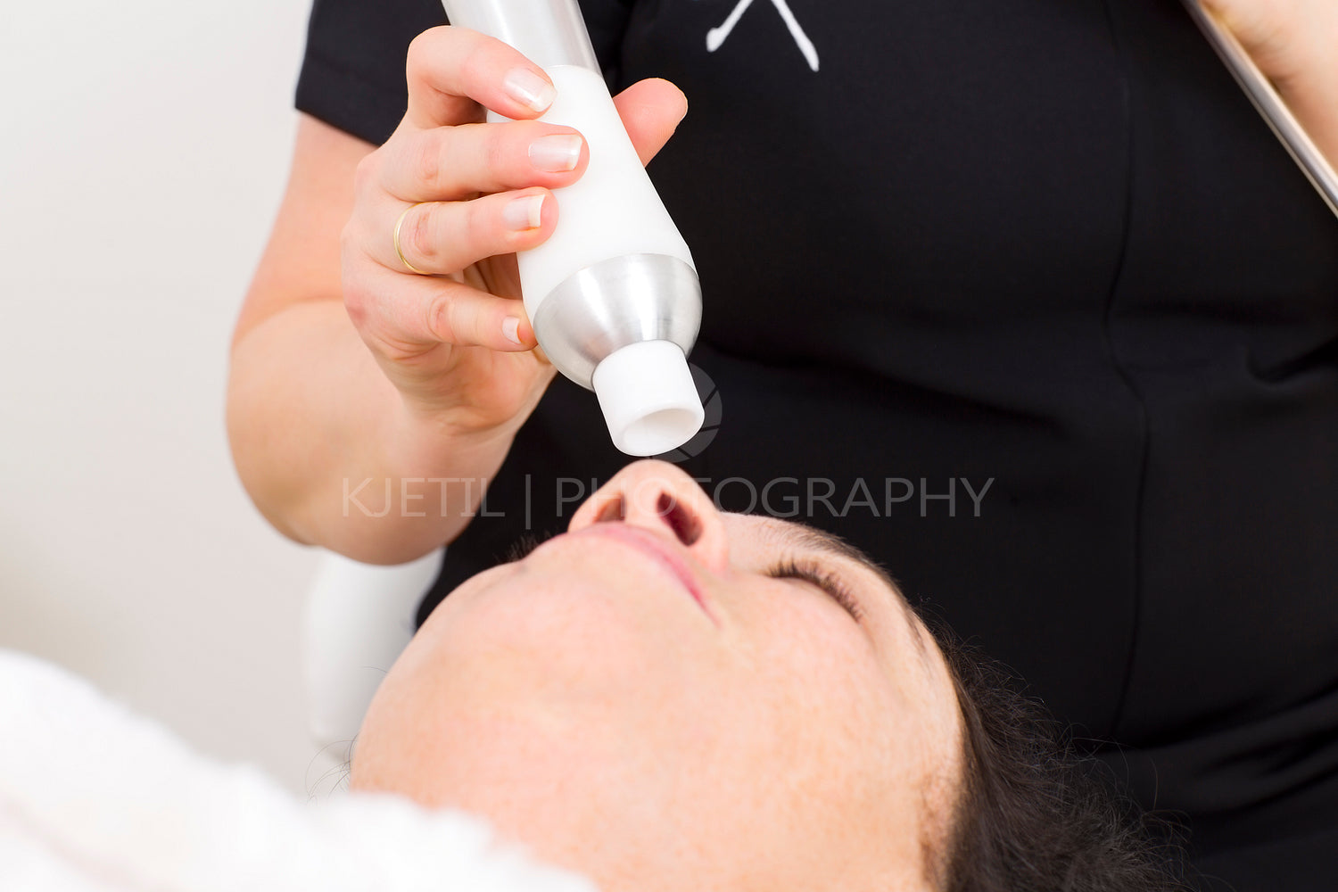 Woman receives face treatments at beauty clinic