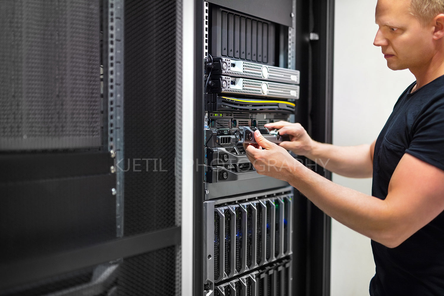 IT Consultant Monitors Servers In Data Center