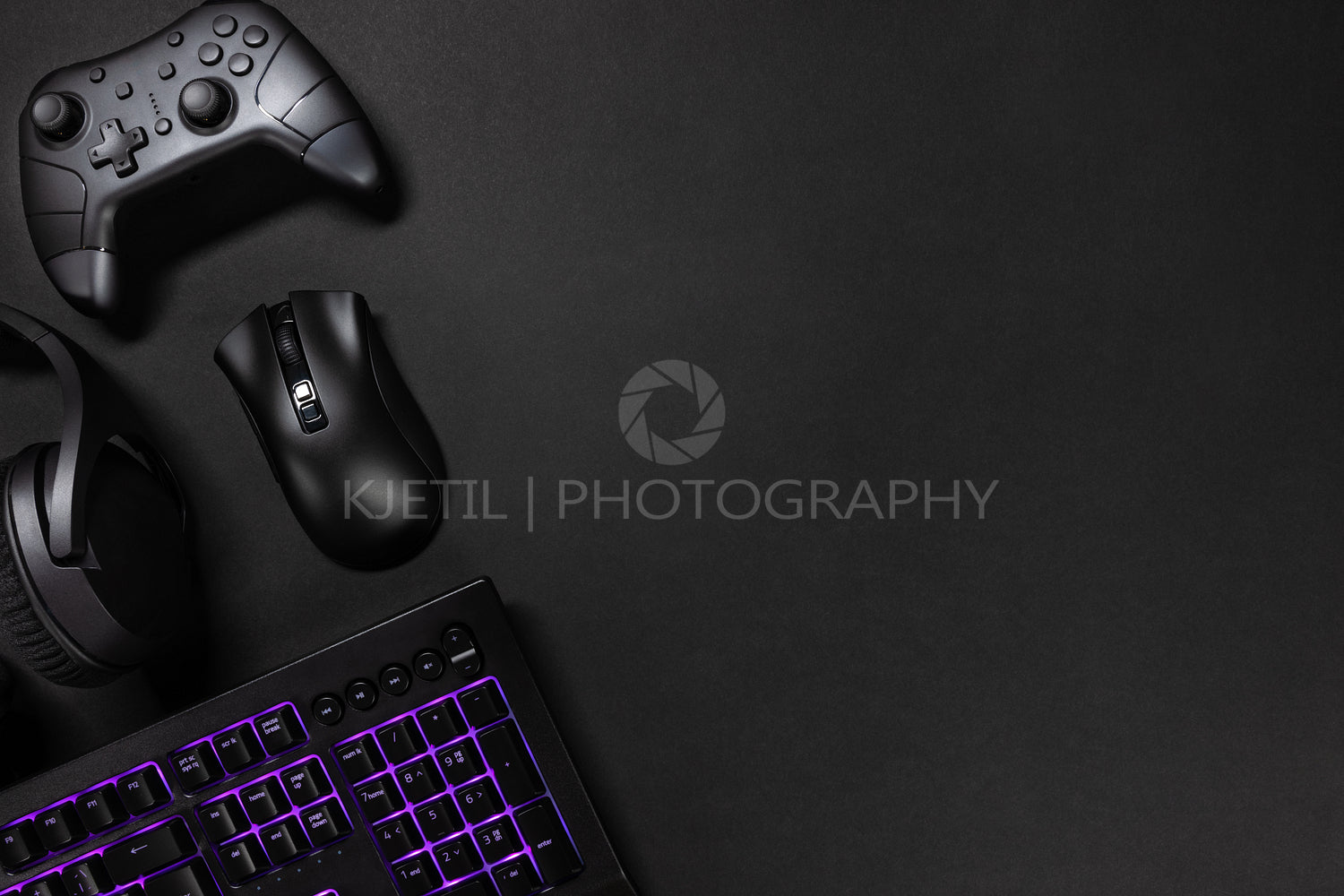 Purple lit keyboard by game controller and mouse