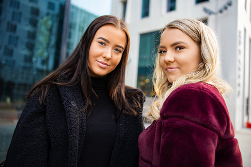 Close Portrait Of Two Smiling Beautiful Young Women Friends In City