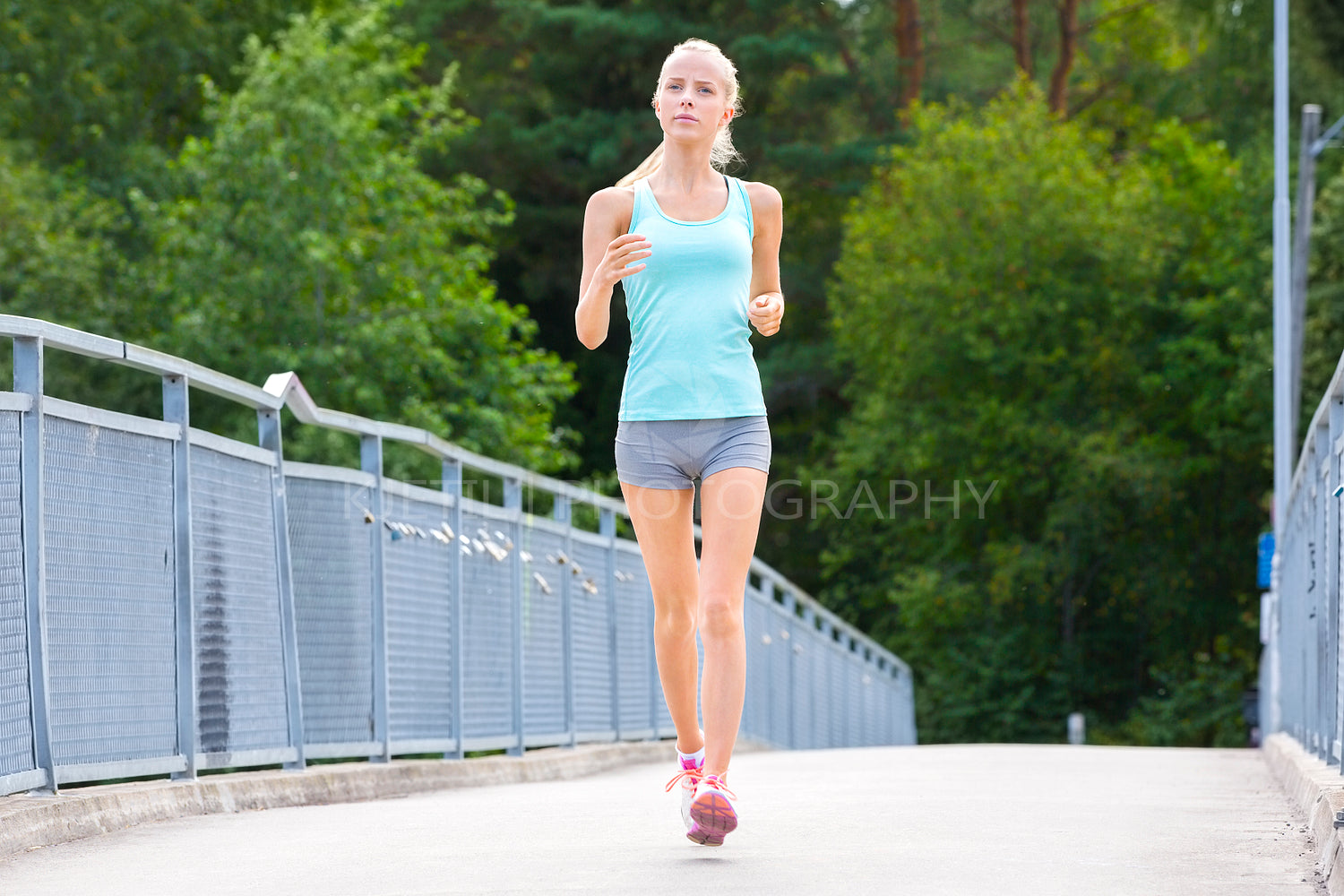 Young running woman trains her stamina outdoor