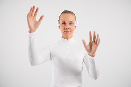 Woman wearing virtual reality smartglasses and gesturing