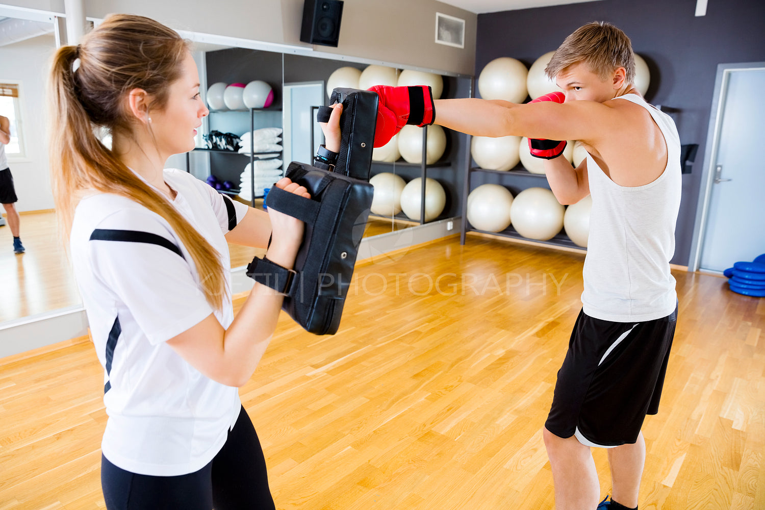 Boxer Punching Bag Held By Female Instructor