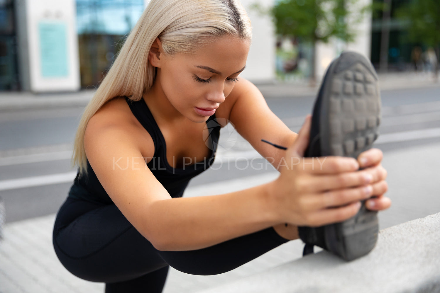 Gorgeous young Woman Doing Stretching Exercise At Sidewalk In City