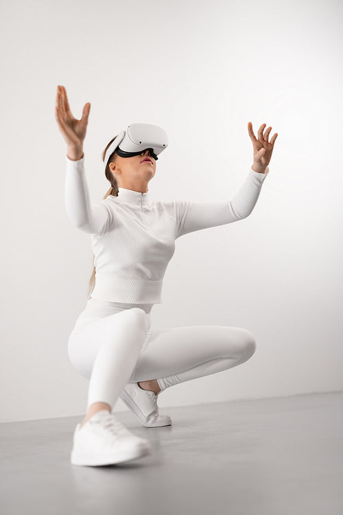 Futuristic looking woman with VR headset exploring virtual reality metaverse world