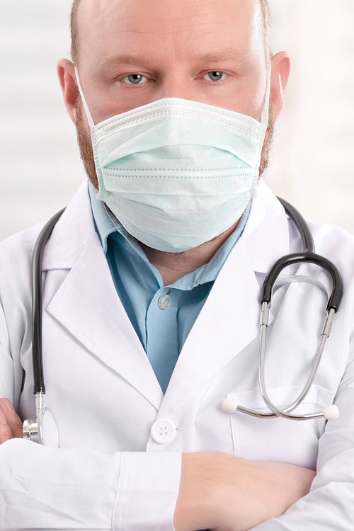 Portrait of a serious doctor wearing surgical face mask and stethoscope