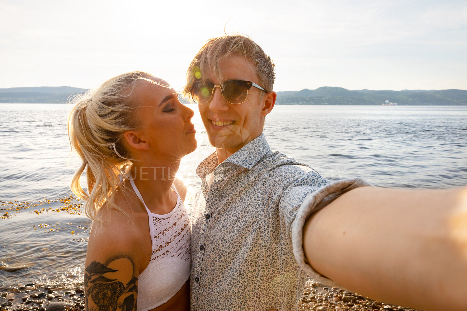 Happy Young Man Taking Selfie With Girlfriend At Beach