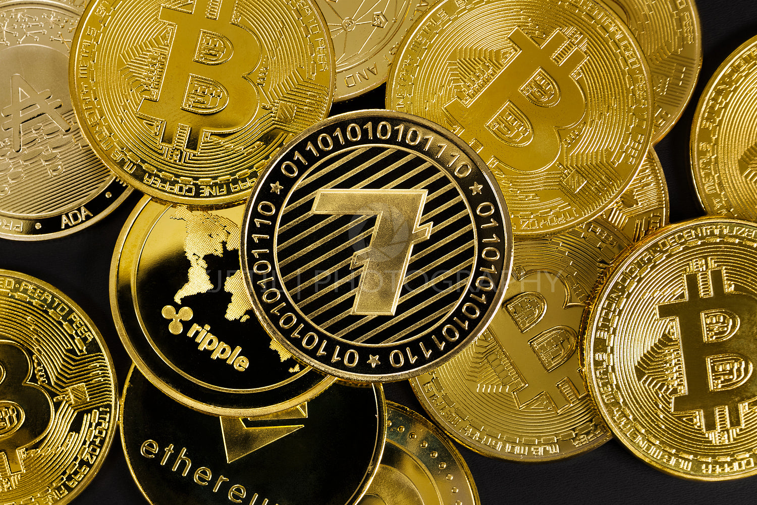 Close-up of litecoin crypto coin on top of various cryptocurrencies