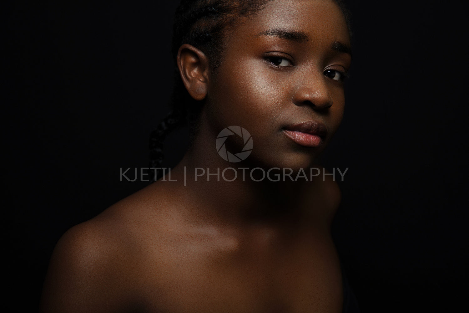 Confident and beautiful african woman with dark skin on black bakground
