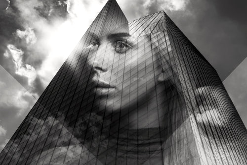 Double exposure portrait of beautiful blonde woman merged with urban city