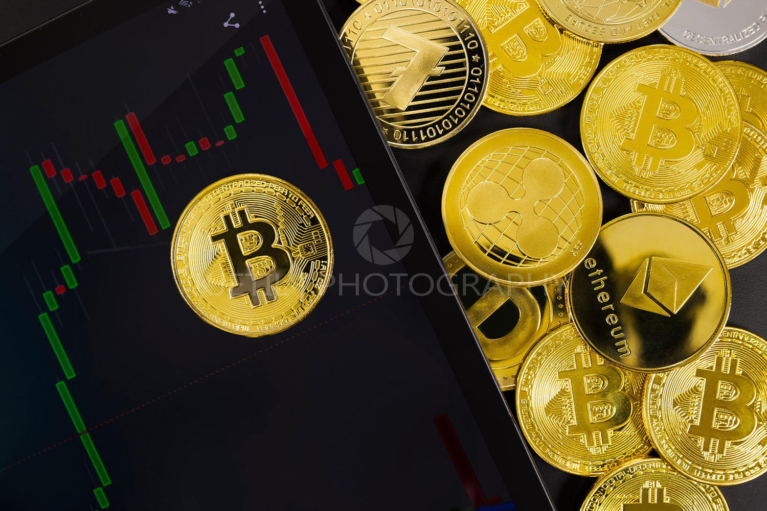 Bitcoin on digital tablet with graph by various coins