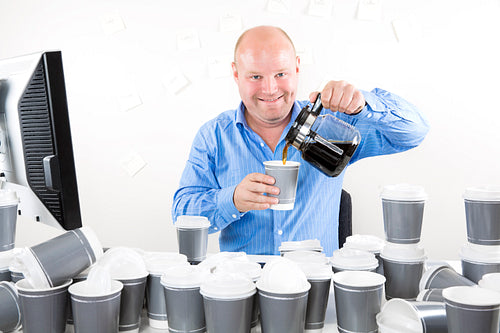 Happy office worker drinks too much coffee