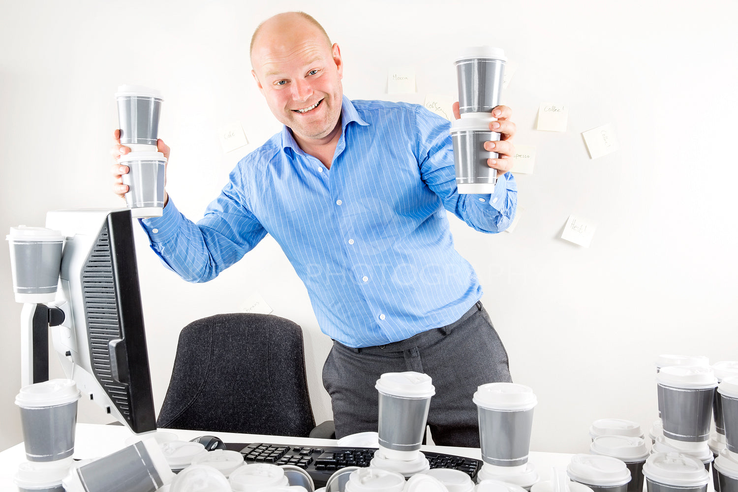 Happy businessman drinks too much coffee