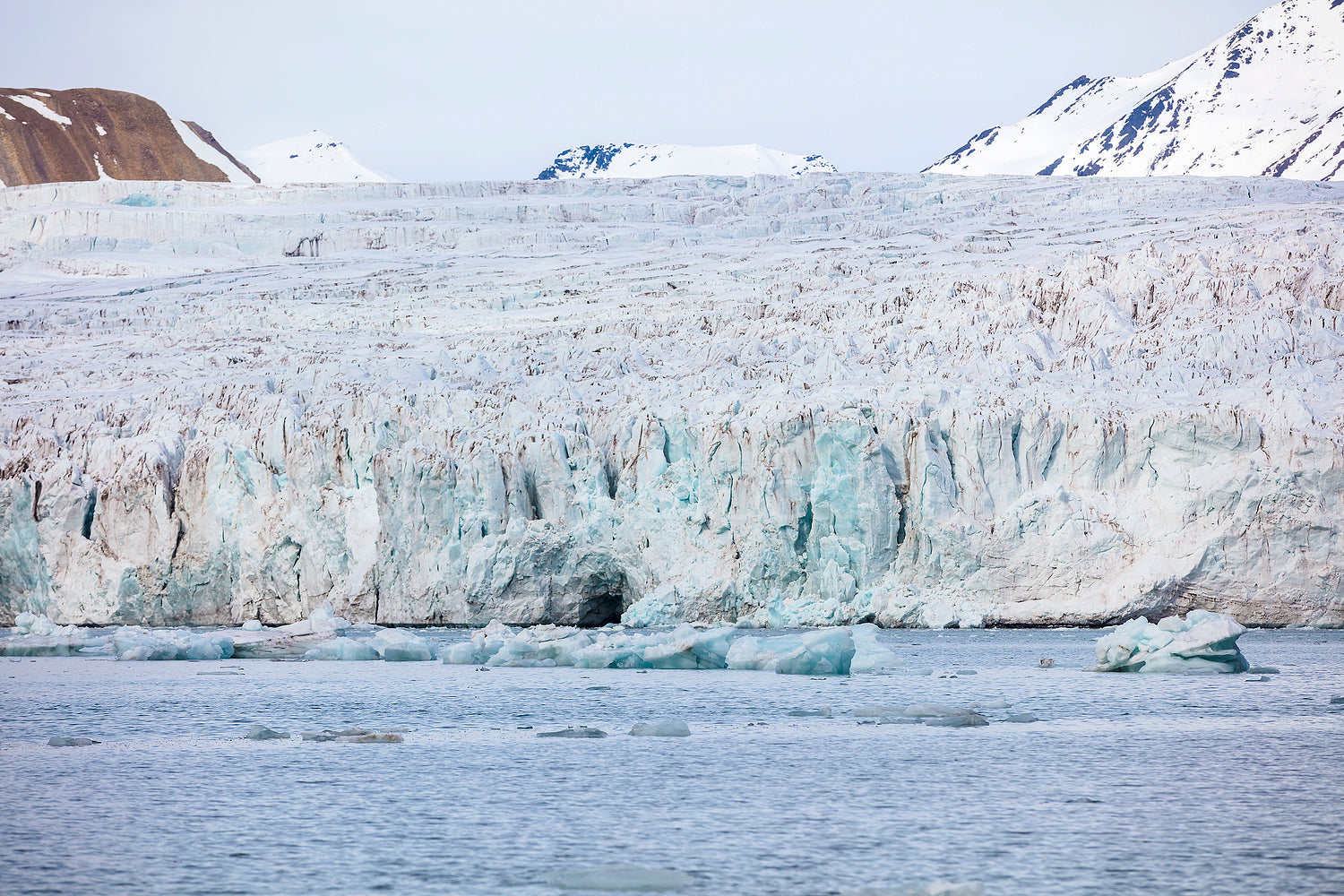 Floating sea ice in front of massive glacier in arctic