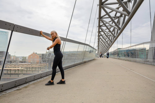 Woman Checking Heart Rate Using Smartwatch After Workout On Bridge